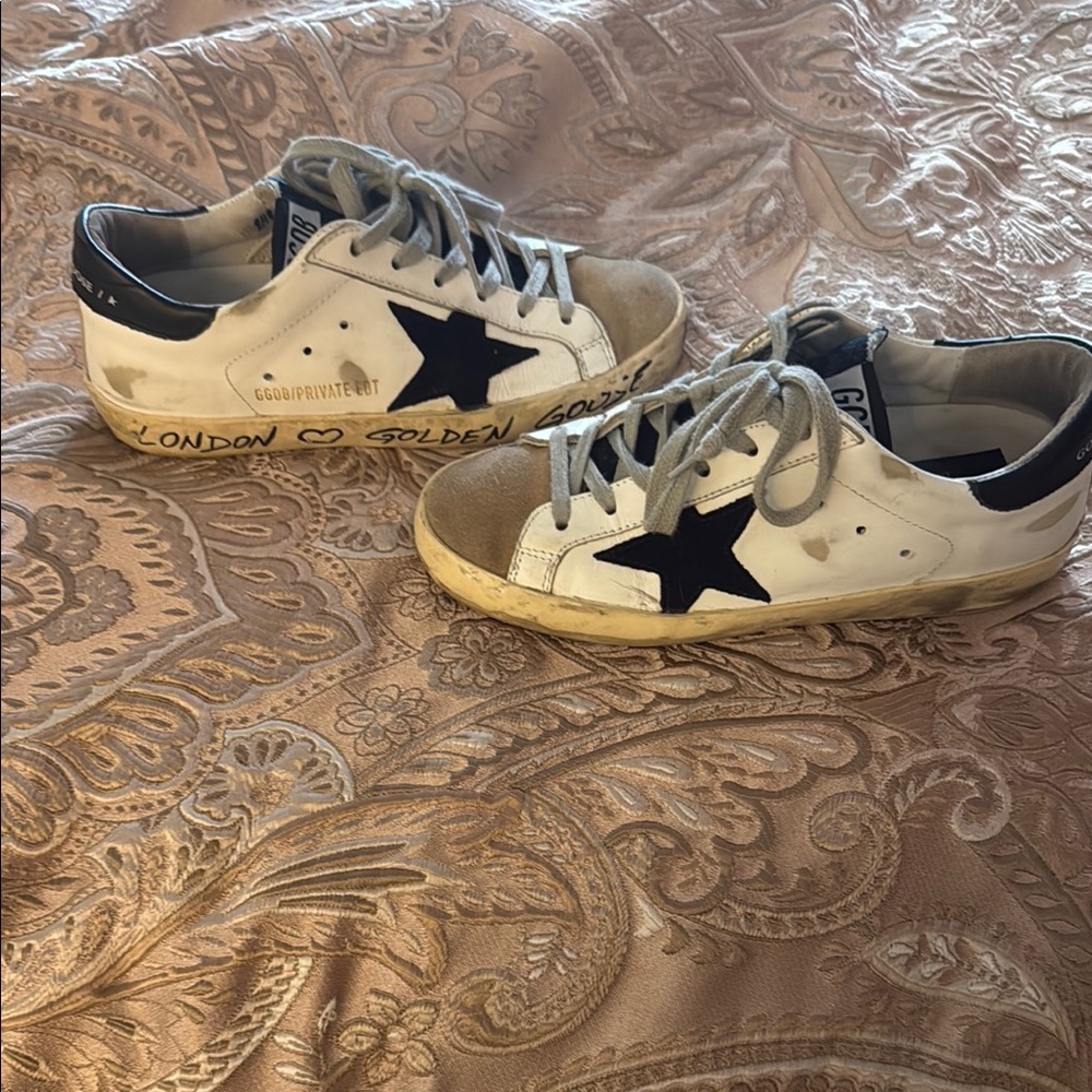 Golden Goose White Sneakers with Black Star and Gold Details